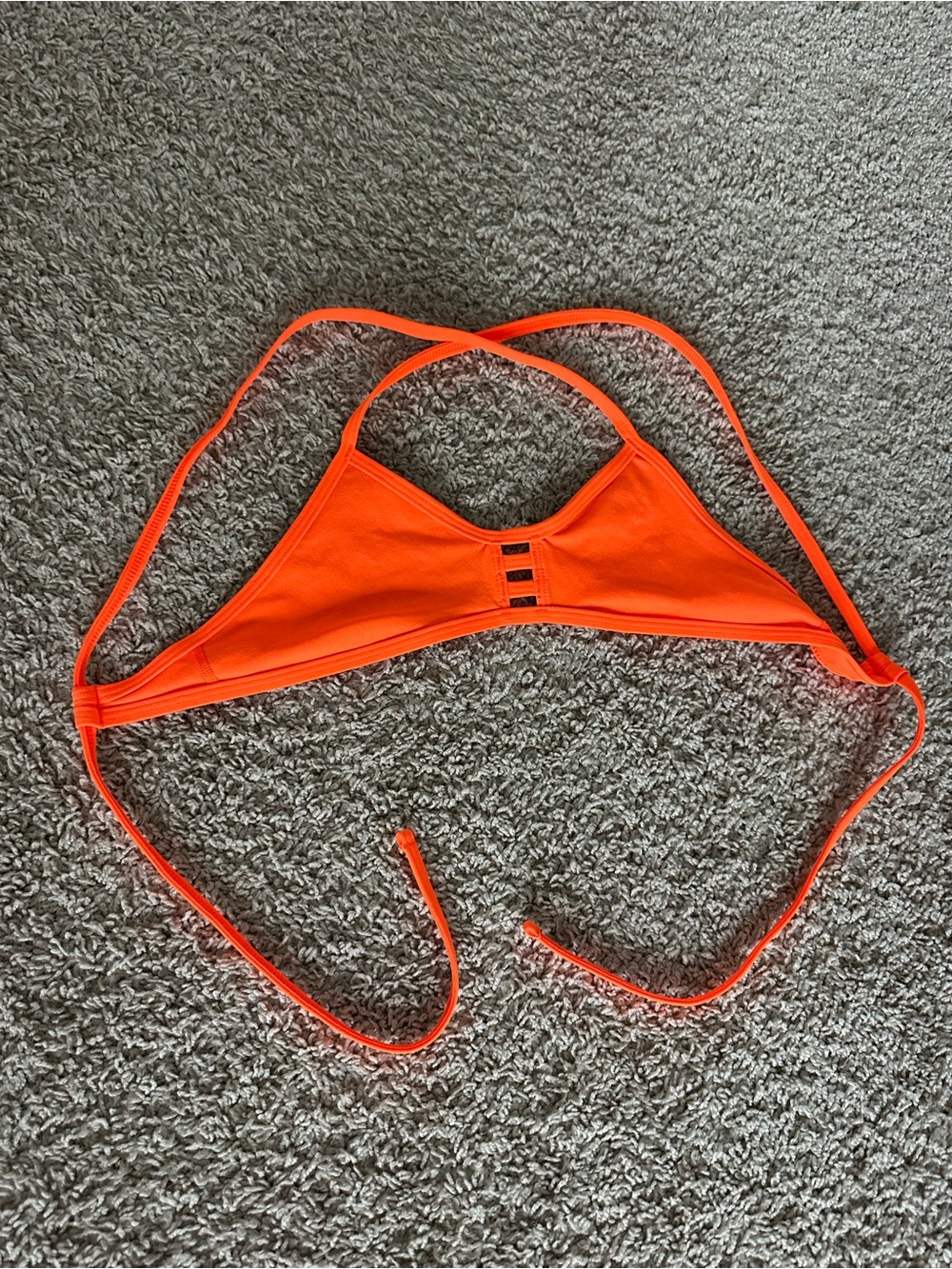 Jolyn “tomcat” orange bikini top in a medium